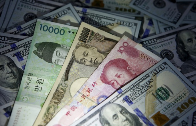 South Korean won, Chinese yuan and Japanese yen notes are seen on U.S. 100 dollar notes in this picture illustration taken in Seoul, South Korea