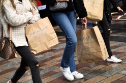 People carry Primark shopping bags after retail restrictions due to coronavirus disease (COVID-19) eased, in Belfast, Northern Ireland,