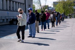 People line up outside a newly reopened career center for in-person appointments in Louisville, U.S.,