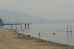  Swimmers cool off in the Thompson River under a blanket of smoke from nearby wildfires in Kamloops, British Columbia, Canada 
