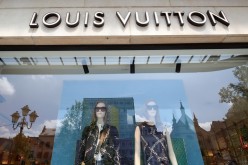 A logo of luxury goods company Louis Vuitton is seen at the entrance of a shop in Brussels, Belgium