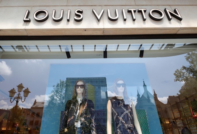 A logo of luxury goods company Louis Vuitton is seen at the entrance of a shop in Brussels, Belgium