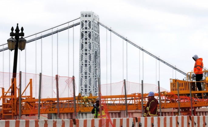 Construction workers are seen at the site of a large public infrastructure reconstruction project of an elevated roadway and bridges in upper Manhattan in New York City,