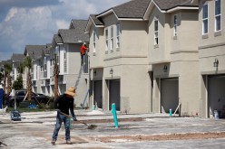 A carpenter works on building new townhomes that are still under construction while building material supplies are in high demand in Tampa, Florida, U.S.