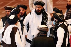 Taliban delegates speak during talks between the Afghan government and Taliban insurgents in Doha,