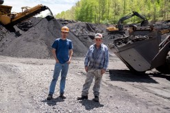 Troy Mullins, 20, and father Cosam Mullins, 86, pose for their portrait at an Abandoned Mine Land reclamation site where they both operate heavy equipment in Clinchco, western Virginia, U.S