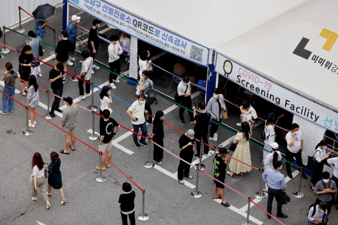 People wait in line for a coronavirus disease (COVID-19) test at a testing site which is temporarily set up at a public health center in Seoul, South Korea,