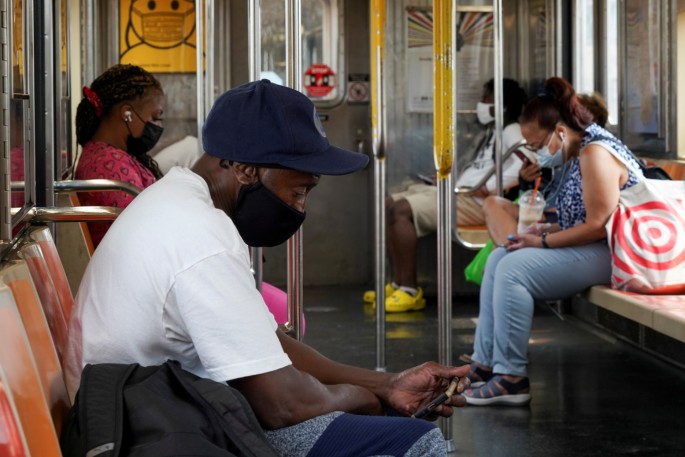 People wearing face coverings due to the coronavirus disease (COVID-19) pandemic ride the subway in New York City, U.S.