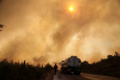 Firefighters extinguish a wildfire in the Mazi region near Bodrum, Turkey, 