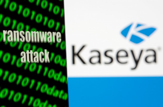 A smartphone with the words "Ransomware attack" and binary code is seen in front of the Kaseya logo in this illustration taken, 