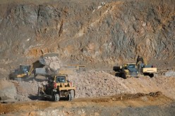 Wheel loaders fill trucks with ore at the MP Materials rare earth mine in Mountain Pass, California, U.S. 