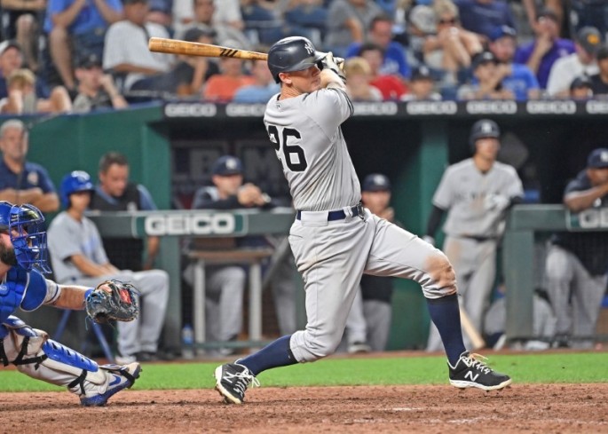 Aug 9, 2021; Kansas City, Missouri, USA; New York Yankees second baseman DJ LeMahieu (26) doubles in a run against the Kansas City Royals during the eleventh inning