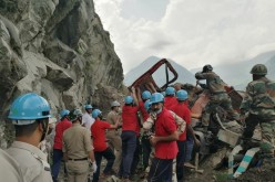 Indo-Tibetan Border Police (ITBP) personnel remove a damaged truck during a rescue operation at the site of a landslide in Kinnaur district in the northern state of Himachal Pradesh, India,