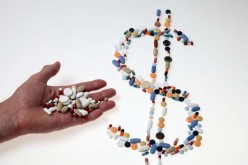 Pharmaceutical tablets and capsules are arranged in the shape of a U.S. dollar sign on a table in this picture illustration taken in Ljubljana
