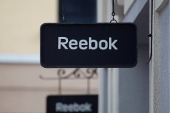 Boards with Reebok store logo are seen on a shopping center at the outlet village Belaya Dacha outside Moscow, Russia,