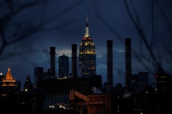 The Empire State Building is illuminated behind the Con Edison Power Plant in Manhattan, New York City, New York, U.S.