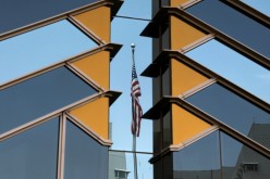 The U.S. flag is reflected on the windows of the U.S. Embassy in Kabul, Afghanistan