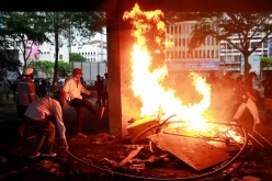 Demonstrators burn items during a protest for the government's handling of the coronavirus disease (COVID-19) pandemic, in Bangkok, Thailand