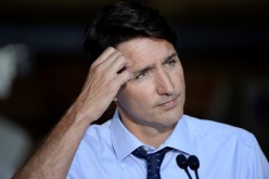 Canada's Prime Minister Justin Trudeau looks on during a news conference after visiting ETI Converting Equipment during his election campaign tour in Longueuil, Quebec