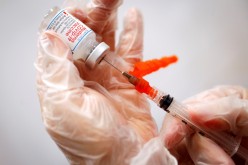 A healthcare worker prepares a syringe with the Moderna COVID-19 Vaccine at a pop-up vaccination site operated by SOMOS Community Care during the COVID-19 pandemic in Manhattan in New York City, New York,