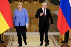 Russian President Vladimir Putin and German Chancellor Angela Merkel attend a news conference following their talks at the Kremlin in Moscow, Russia