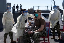 A United States Navy officer from the amphibious ship USS San Diego (LPD 22) receives a vaccine against Coronavirus (COVID-19) at the navy port in Manama