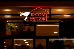 A sign of China's e-commerce company JD.com is seen at its shop at a mall in Shanghai,