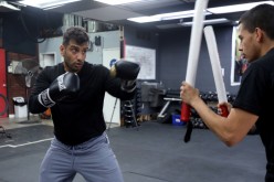 Hamidullah Ehsan, a former interpreter for the U.S. Army in Afghanistan from 2008 to 2012, trains with his boxing coach at a gym in Modesto, California, U.S