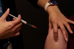 A nurse immuniser administers the AstraZeneca vaccine to a patient at a coronavirus disease (COVID-19) vaccination clinic at the Bankstown Sports Club 