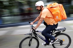 Former Afghan Communication Minister Sayed Sadaat rides a bicycle for his food delivery service job with Lieferando in Leipzig, Germany,