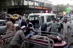 A screen grab shows people carrying an injured person to a hospital after an attack at Kabul airport, in Kabul, Afghanistan