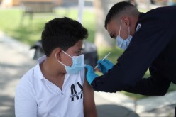  Alessandro Roque, 12, receives a coronavirus disease (COVID-19) vaccination as part of a vaccine drive by the Fernandeno Tataviam Band of Mission Indians in Arleta, Los Angeles, California, U.S.