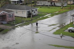 A person walks in a flooded street after Hurricane Ida made landfall in Louisiana, in Kenner, Louisiana, U.S. 