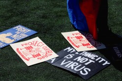 Signs are spread on the ground during a Rally Against Hate to end discrimination against Asian Americans and Pacific Islanders in New York City, U.S.