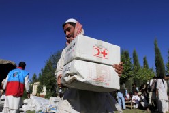 An Afghan man receives aid from the International Federation of the Red Cross and Red Crescent Societies after an earthquake, in Behsud district of Jalalabad province, Afghanistan
