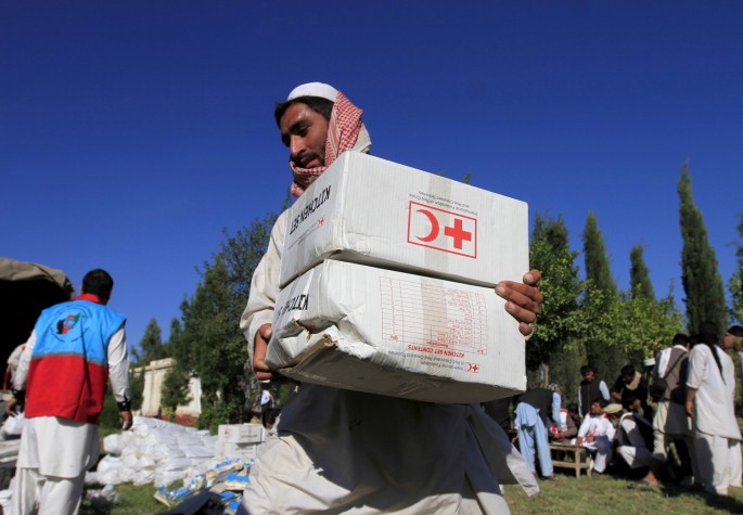 An Afghan man receives aid from the International Federation of the Red Cross and Red Crescent Societies after an earthquake, in Behsud district of Jalalabad province, Afghanistan