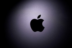 The Apple logo is seen on a Macbook in this illustration photo taken
