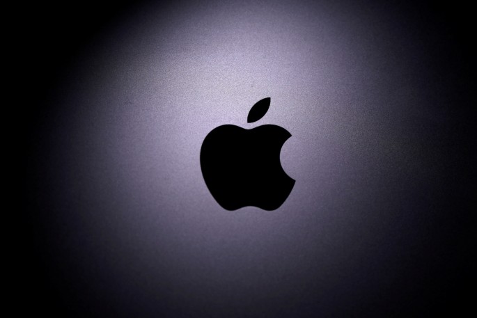 The Apple logo is seen on a Macbook in this illustration photo taken