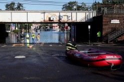 First responders stand by floodwaters to perform rescues of trapped local residents after the remnants of Tropical Storm Ida brought drenching rain, flash floods and tornadoes to parts of the northeast in Mamaroneck, New York,