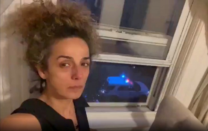 Iranian American journalist Alinejad Masih shows an FBI car guarding outside her apartment in this still image from an undated social media video posted on