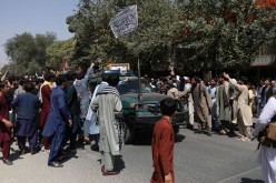Protesters gather around a car with the Taliban flag raised atop it during the anti-Pakistan protest in Kabul, Afghanistan, 