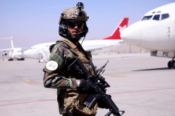 A member of Taliban forces stands guard at Hamid Karzai International Airport in Kabul,