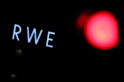 The logo of German utility and energy supplier RWE is pictured next to a traffic light outside RWE's lignite power plant in Weisweiler near the western German city of Aachen, Germany