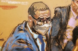 R. Kelly sits with two of his defense attorneys during his sex abuse trial at Brooklyn's Federal District Court in a courtroom sketch in New York, U.S