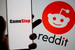 GameStop logo is seen in front of displayed Reddit logo in this illustration taken 