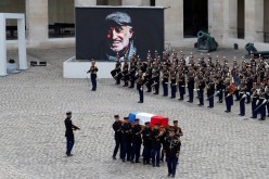 French Republican guards carry the flag-draped coffin of late actor Jean-Paul Belmondo during a ceremony and a national tribute at the Hotel des Invalides in Paris, France