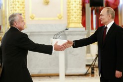 Russian President Vladimir Putin shakes hands with the new U.S. Ambassador to Russia John Sullivan during a ceremony for newly appointed foreign ambassadors to Russia