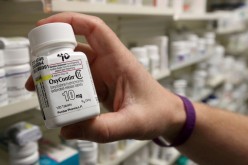 A pharmacist holds a bottle OxyContin made by Purdue Pharma, at a pharmacy in Provo, Utah, U.S., 