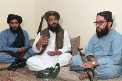 Waheedullah Hashimi (C), a senior Taliban commander, gestures as he speaks with Reuters during an interview at an undisclosed location near Afghanistan-Pakistan border