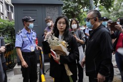 Zhou Xiaoxuan, also known by her online name Xianzi, arrives at a court for a sexual harassment case involving a Chinese state TV host, in Beijing, China
